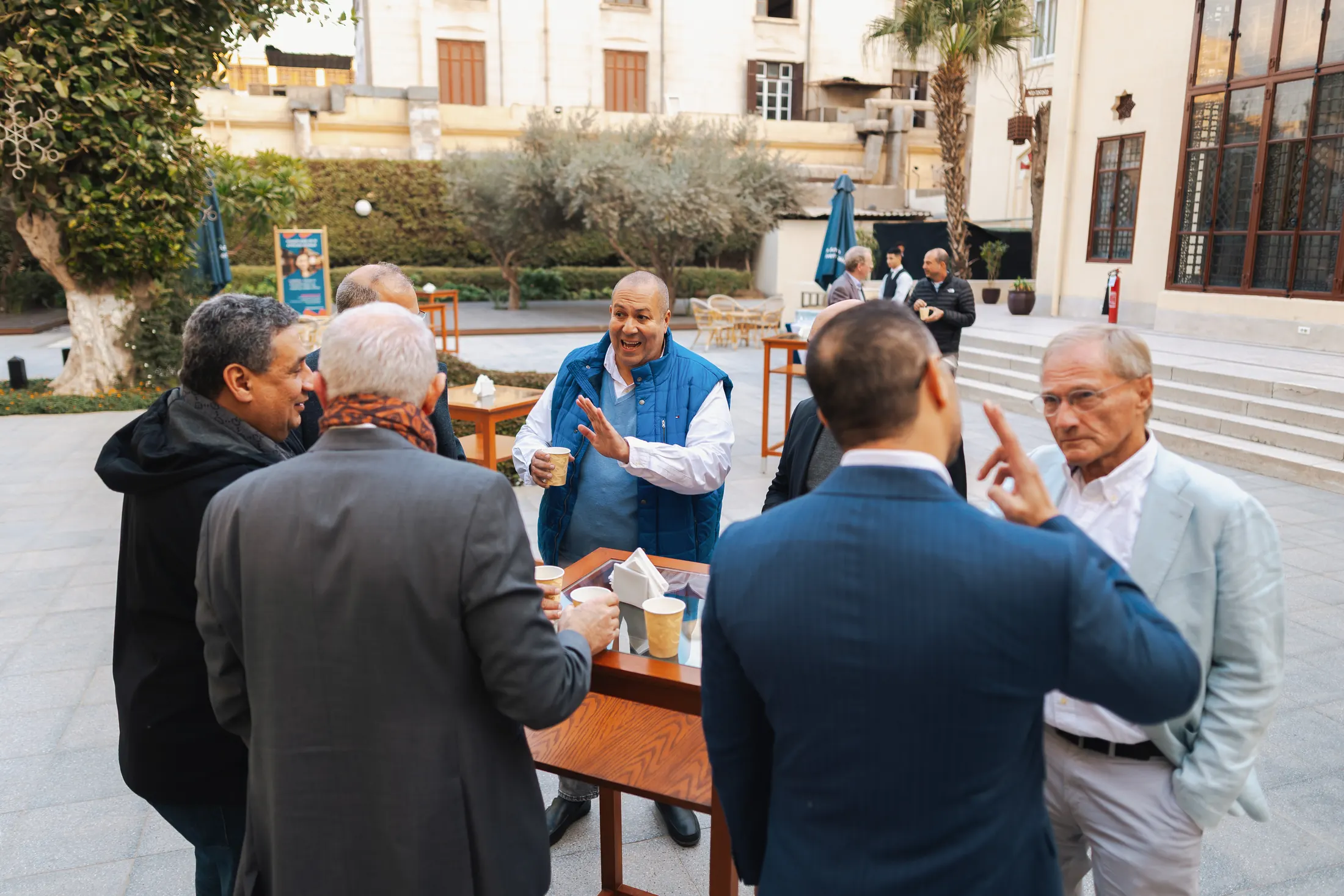 Alumni catching up over coffee at a PGAE gathering.
