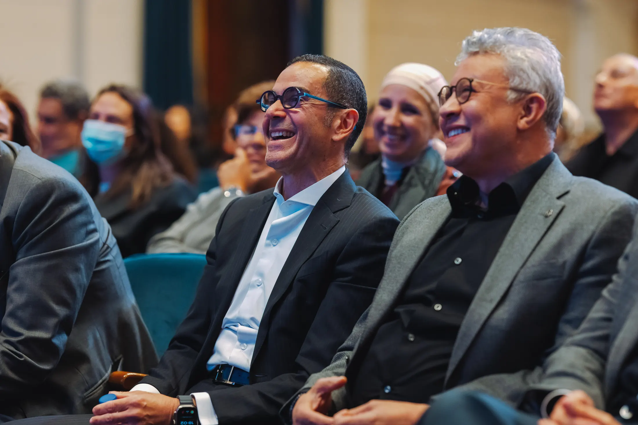 Alumni sharing a laugh during a PGAE event.