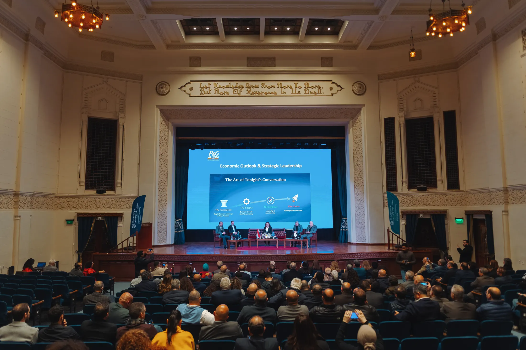 PGAE Academy panel discussion, "Economic Outlook & Strategic Leadership," on stage to a full audience.